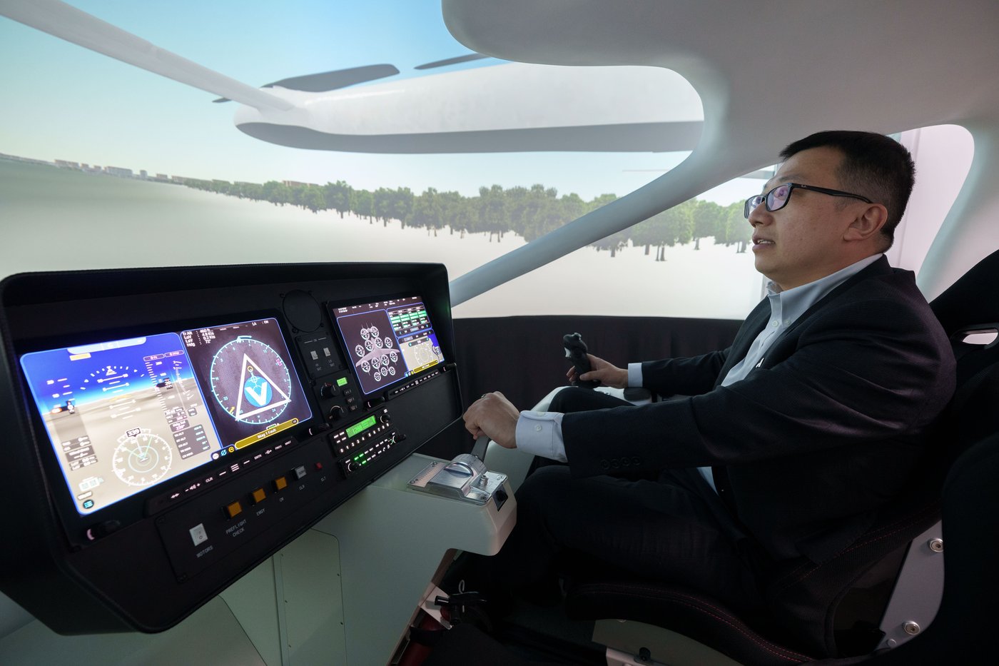 Steven Yang, senior vice president of AutoFlight, demonstrates at a flying simulation of its company eVTOL aircraft in Shanghai, China, on Feb. 24, 2026. (AP Photo/Vincent Thian)