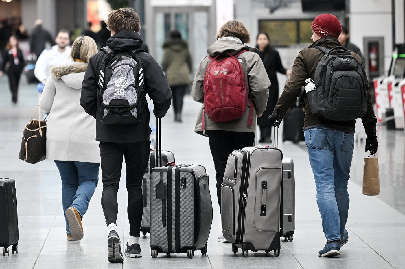 Travellers wheel and carry their luggage through Trudeau airport in Montreal, Friday, January 3, 2025. THE CANADIAN PRESS/Graham Hughes.