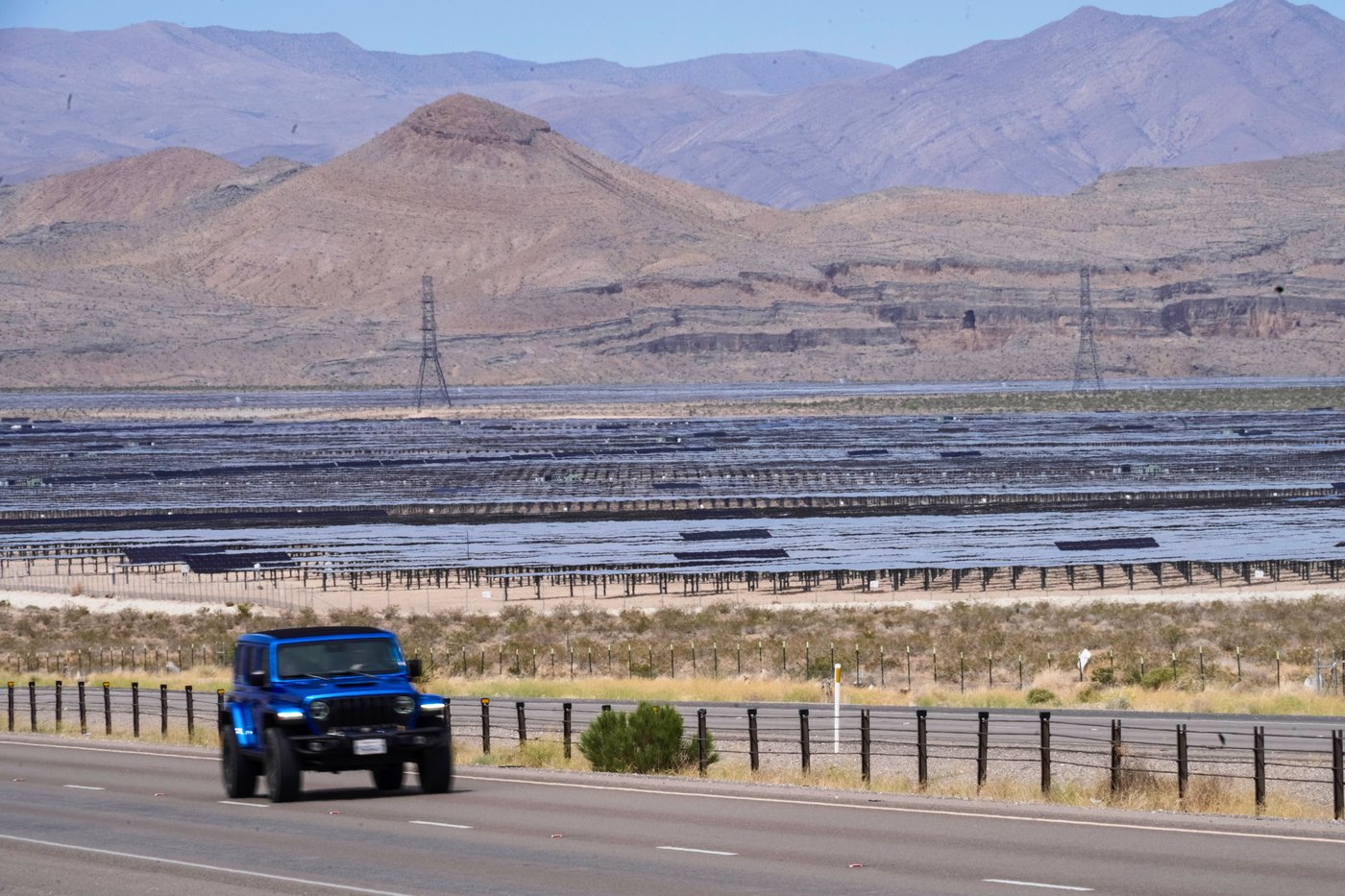 Solar panels stretch out across the desert floor, Thursday, April 2, 2026, in North Las Vegas. (AP Photo/Ty ONeil)