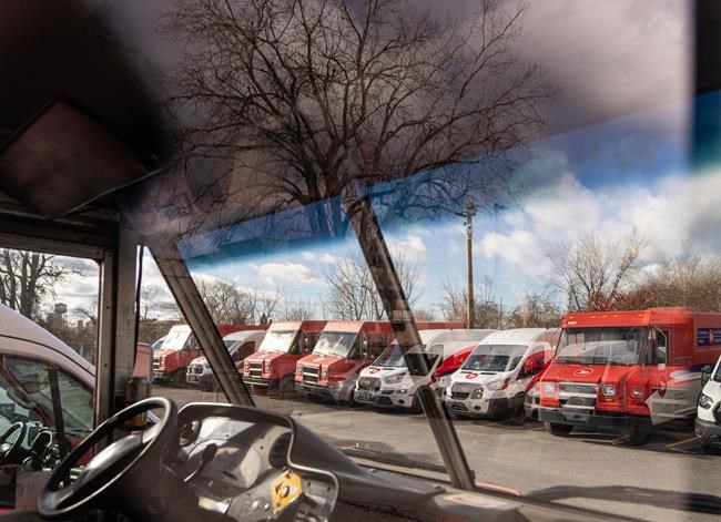 Canada Post mail trucks are seen parked in their distribution centre in Montreal, Wednesday, Nov. 27, 2024. THE CANADIAN PRESS/Christinne Muschi