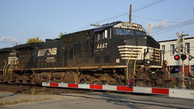 A Norfolk Southern freight train runs through a crossing in Homestead, Pa., Wednesday, Sept. 14, 2022. (AP Photo/Gene J. Puskar)