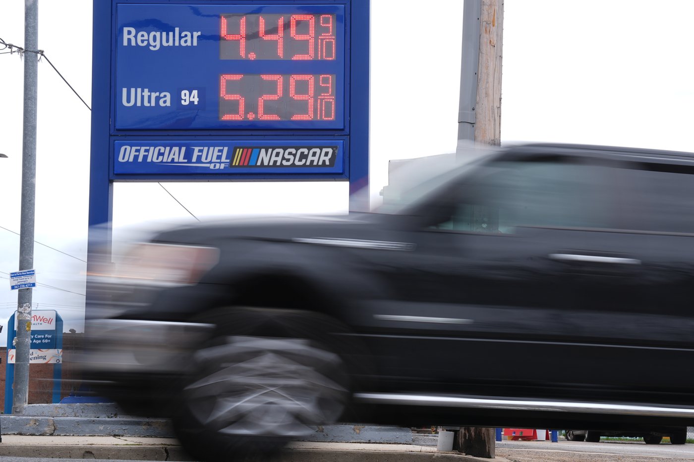 A vehicle passes a gasoline price board at a filling station in Philadelphia, Friday, March 27, 2026. (AP Photo/Matt Rourke)