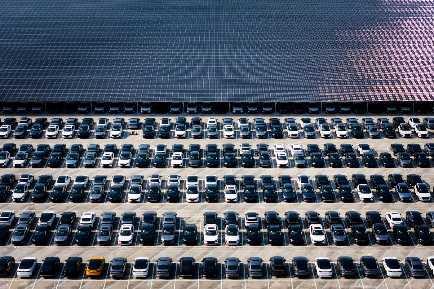 FILE - New cars wait for shipment in a parking lot partially covered by solar panels at the distribution center of Changan Auto, in southwest China's Chongqing Municipality on July 6, 2025. (Chinatopix via AP, File)