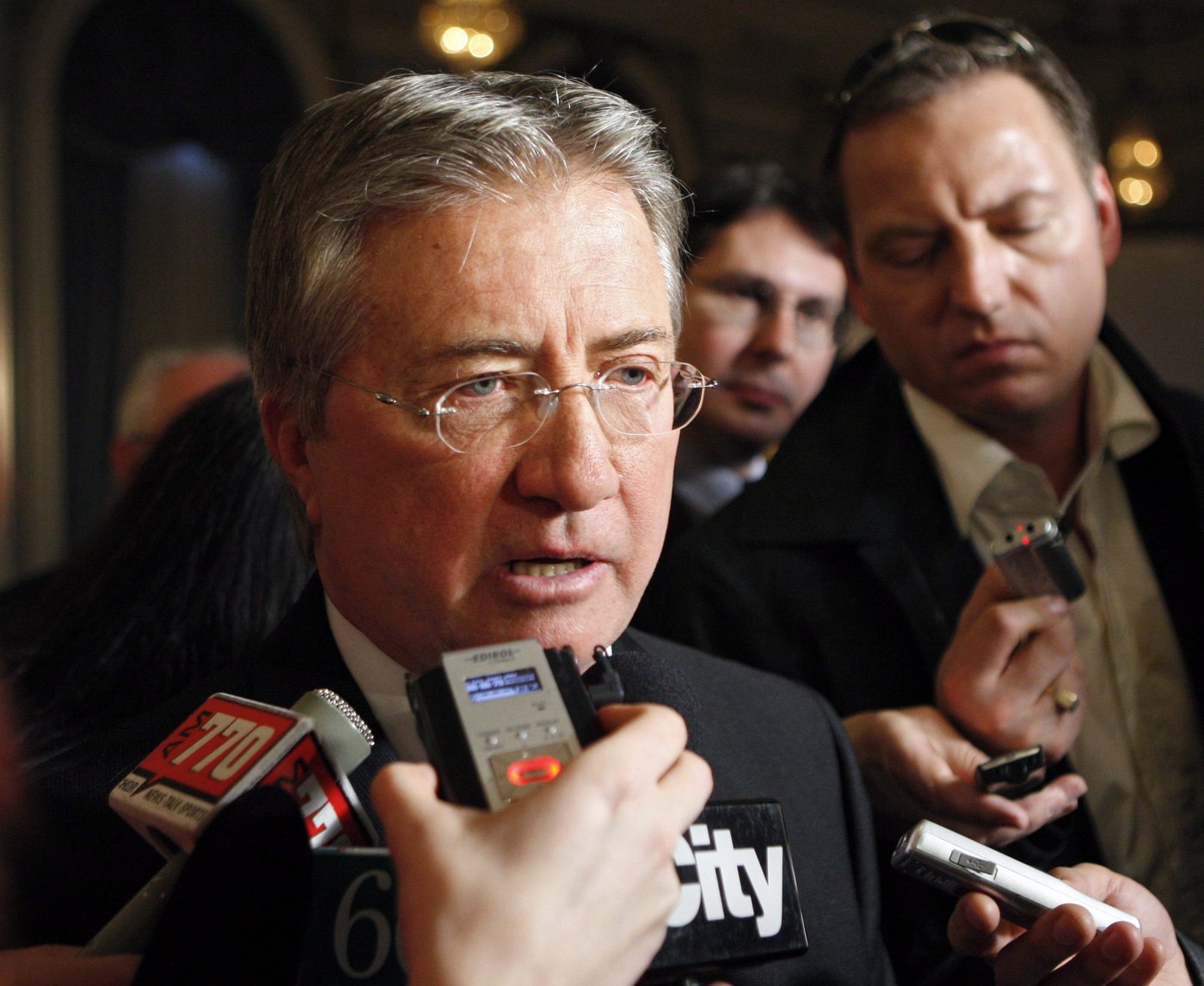 Former Newfoundland and Labrador premier Danny Williams, left, speaks to the media after addressing the Calgary Chamber of Commerce in Calgary, Thursday, Dec. 3, 2009. THE CANADIAN PRESS/Jeff McIntosh