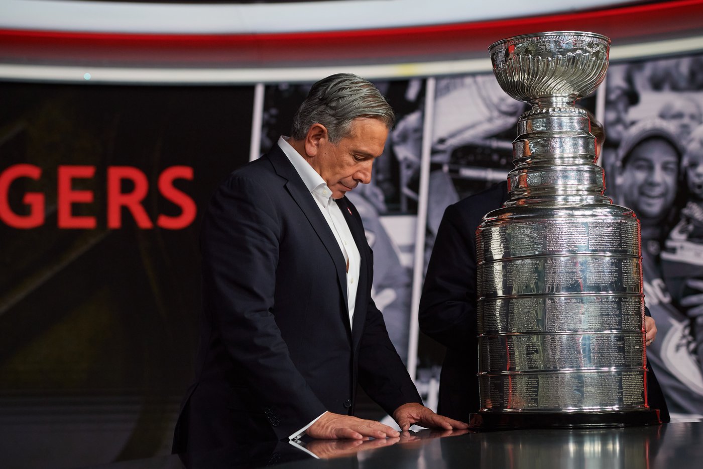 Rogers Communications President and CEO Tony Staffieri stands next to the Stanley Cup following a press conference in Toronto on Wednesday, April 2, 2025. THE CANADIAN PRESS/Sammy Kogan