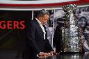 Rogers Communications President and CEO Tony Staffieri stands next to the Stanley Cup following a press conference in Toronto on Wednesday, April 2, 2025. THE CANADIAN PRESS/Sammy Kogan