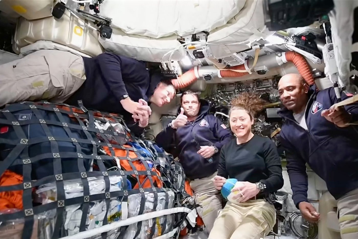 This image from video provided by NASA shows the Artemis II crew, from left, Canadian astronaut and mission specialist Jeremy Hansen, Commander Reid Wiseman, mission specialist Christina Koch and pilot Victor Glover as they speak with NASA Mission Control in a video conference while en route to the moon, Thursday, April 2, 2026. (NASA via AP)