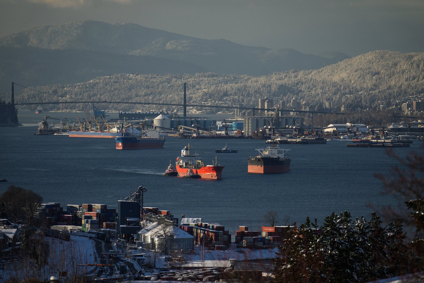 Tugboats escort the chemical tanker Zao Galaxy through the harbour with West Vancouver in the background on Wednesday, Dec. 21, 2022. THE CANADIAN PRESS/Darryl Dyck