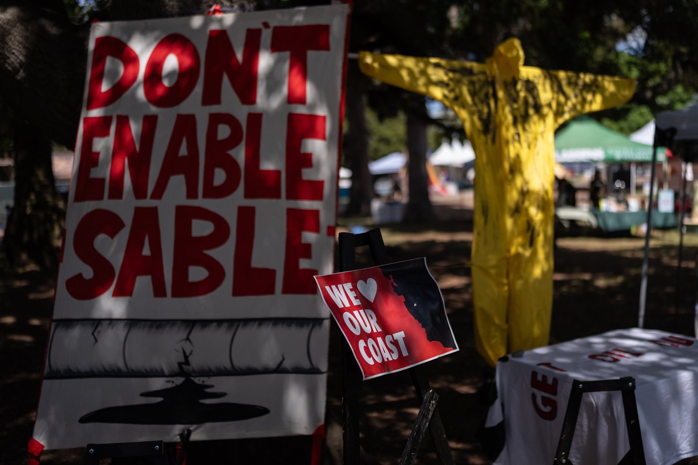 Signs opposing Sable Offshore Corp.'s offshore oil operations are displayed at the Santa Barbara Earth Day Festival in Santa Barbara, Calif., Sunday, April 26, 2026. (AP Photo/Jae C. Hong)