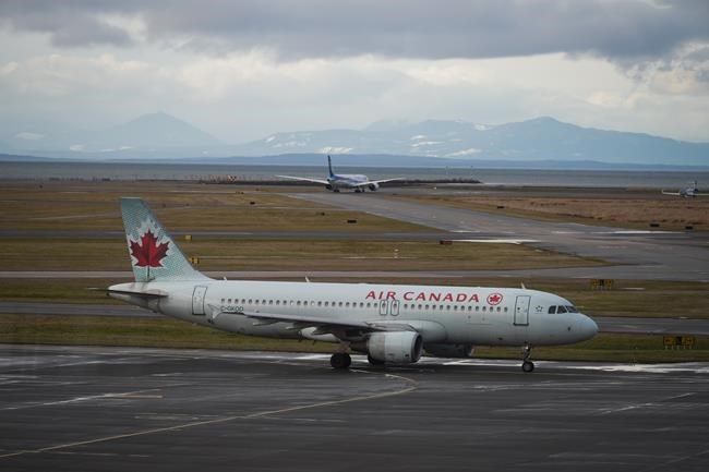 An Air Canada aircraft taxis at Vancouver International Airport after operations returned to normal after last week's snowstorm, in Richmond, B.C., Monday, Dec. 26, 2022. Air Canada announced that executive vice-president and CFO Amos Kazzaz is retiring at the end of June. THE CANADIAN PRESS/Darryl Dyck