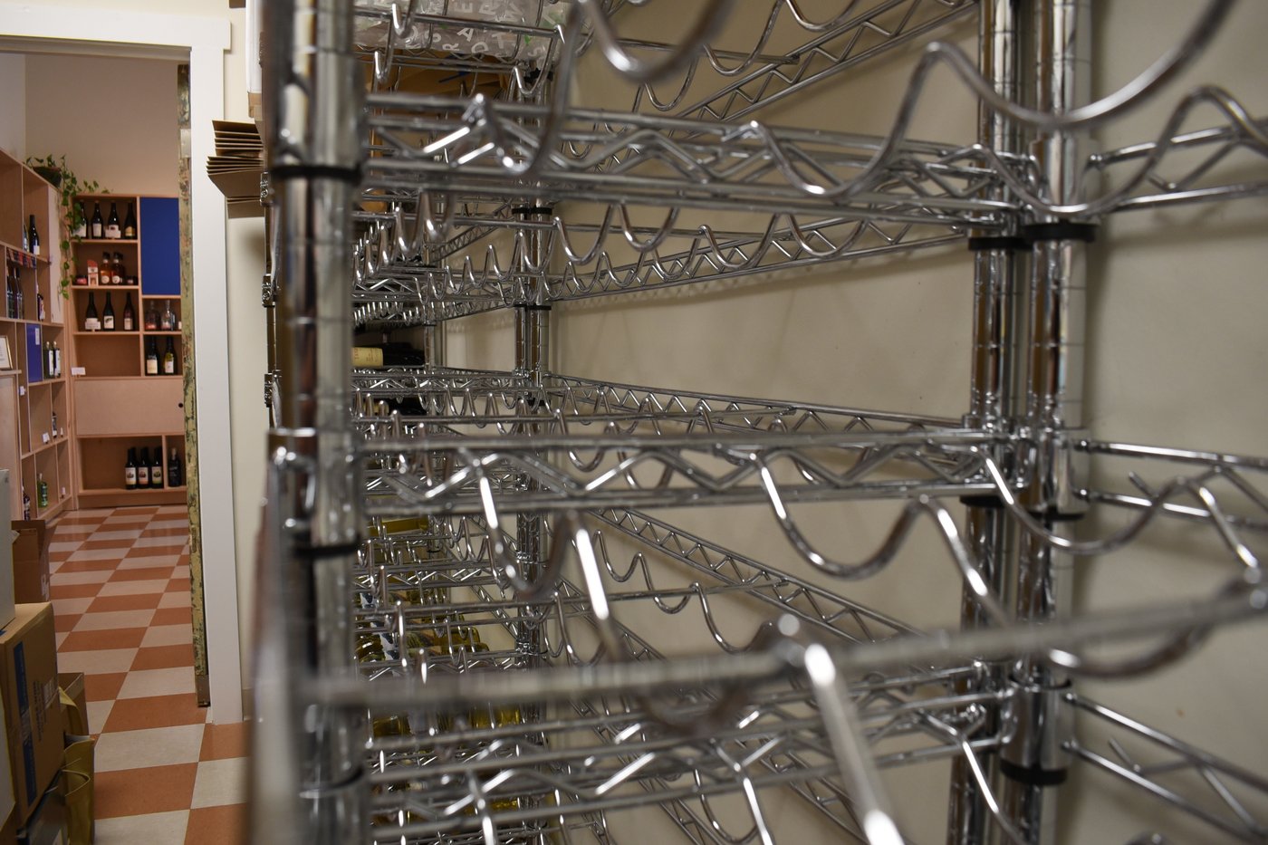 A backroom wine rack sits empty at the Levure Bottle Shop in Jackson, Miss., on Wednesday, April 15, 2026. (AP Photo/Sophie Bates)