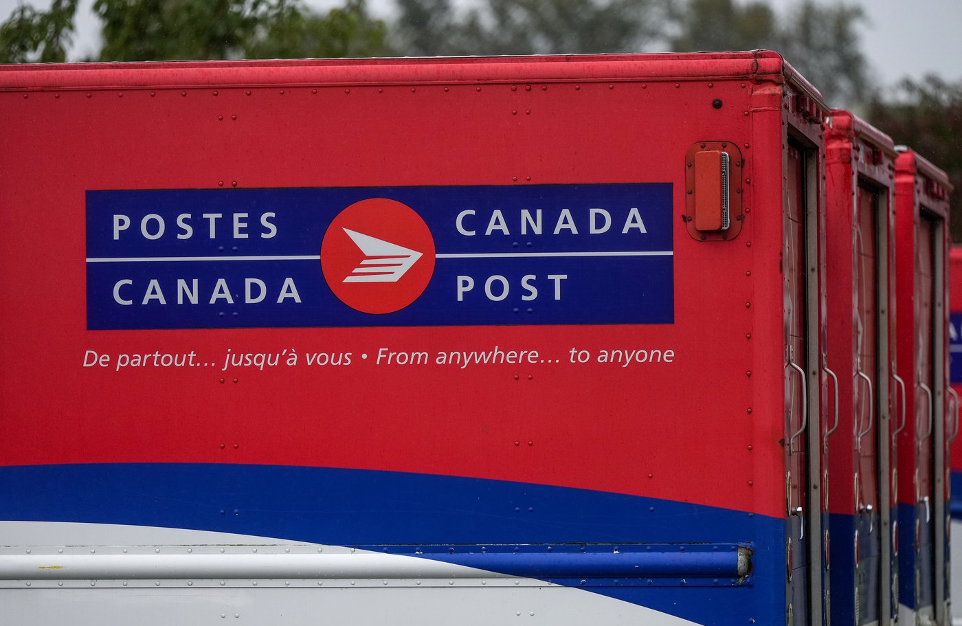 Vehicles sit idle at a Canada Post delivery depot, in Burnaby, B.C., on Monday, Sept. 29, 2025. THE CANADIAN PRESS/Darryl Dyck