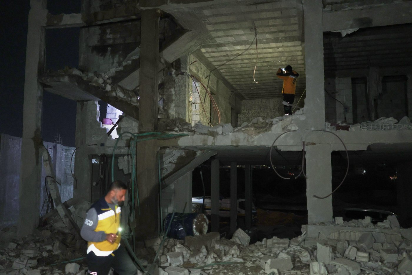FILE — Members of the Syrian Civil Defense inspect a building after debris from an Iranian missile fell, injuring at least four people, including three children, according to Syria's state news agency SANA, in the town of Ain Terma, near Damascus, Syria, March 1, 2026. (AP Photo/Ghaith Alsayed, File)