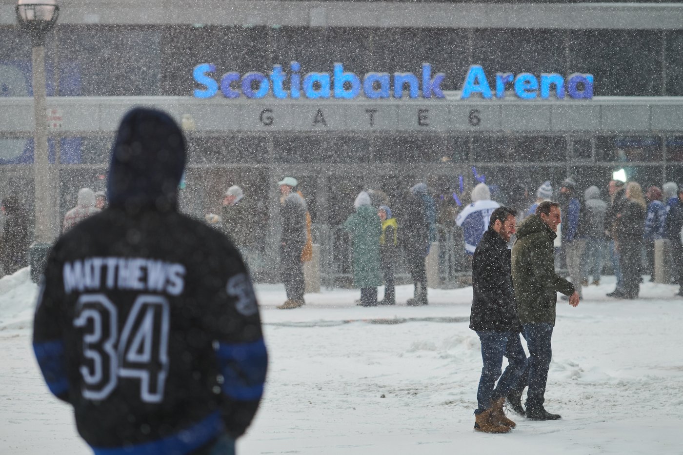 Toronto Maple Leafs fans line up in a snowstorm as they wait to enter Scotiabank arena ahead of NHL hockey action against the Colorado Avalanche in Toronto, on Sunday, Jan. 25, 2026. THE CANADIAN PRESS/Sammy Kogan