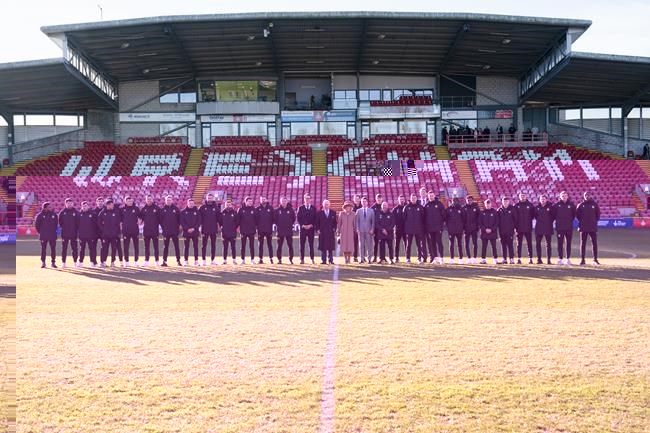 FILE - Britain's King Charles III and Camilla, the Queen Consort meet Wrexham Soccer team co owners, US actors Ryan Reynolds and Rob McElhenney and players during their visit to Wrexham Association Football Club's Racecourse Ground, in Wrexham, England, Friday, Dec. 9, 2022. The Hollywood owners of Wrexham are still learning the vernacular of British soccer. They don’t need any advice, though, in setting the scene for this weekend’s FA Cup match against second-division Sheffield United. (Arthur Edwards/Pool Photo via AP, File)