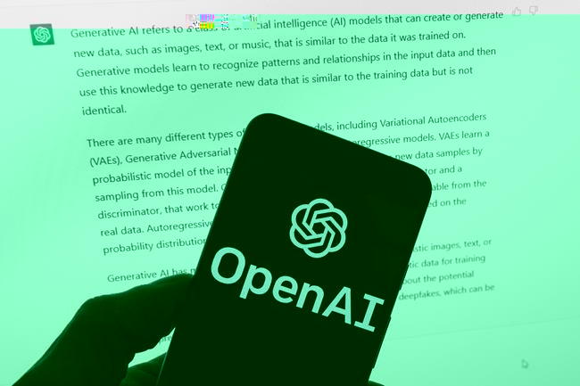 FILE - The OpenAI logo is seen on a mobile phone in front of a computer screen displaying output from ChatGPT, March 21, 2023, in Boston. Digital news outlets The Intercept, Raw Story and AlterNet are joining the fight against unauthorized use of their journalism in artificial intelligence, filing a copyright-infringement lawsuit Wednesday, Feb. 28, 2024, against ChatGPT owner OpenAI. (AP Photo/Michael Dwyer, File)