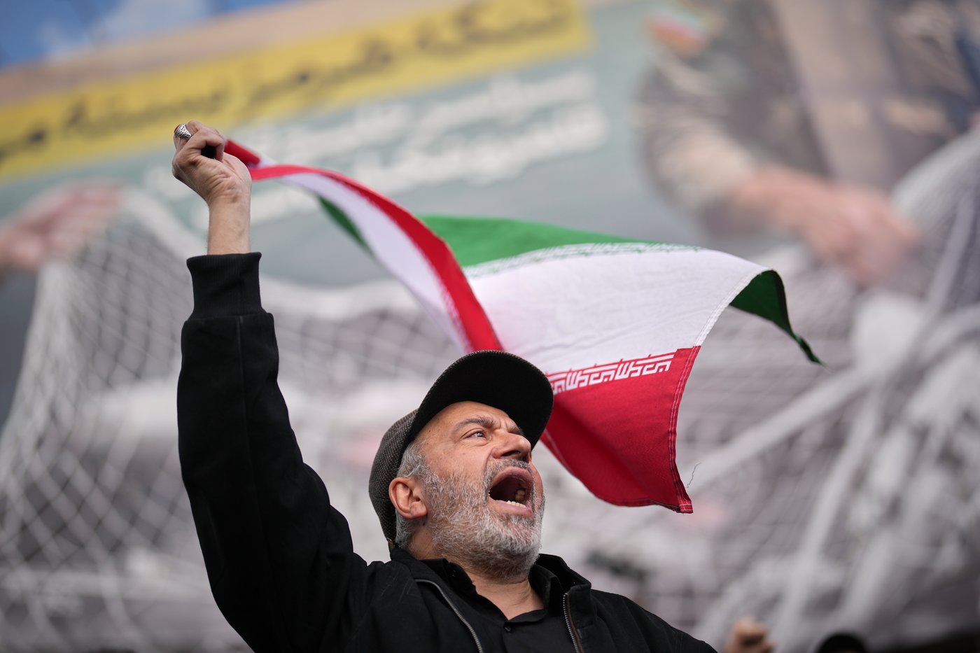 A government supporter chants slogans during a gathering after the announcement of a two-week ceasefire with the United States and Israel in Tehran, Iran, Wednesday, April 8, 2026. (AP Photo/Francisco Seco)