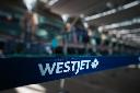 A WestJet logo is seen in the domestic check-in area at Vancouver International Airport, in Richmond, B.C., on May 19, 2023. THE CANADIAN PRESS/Darryl Dyck