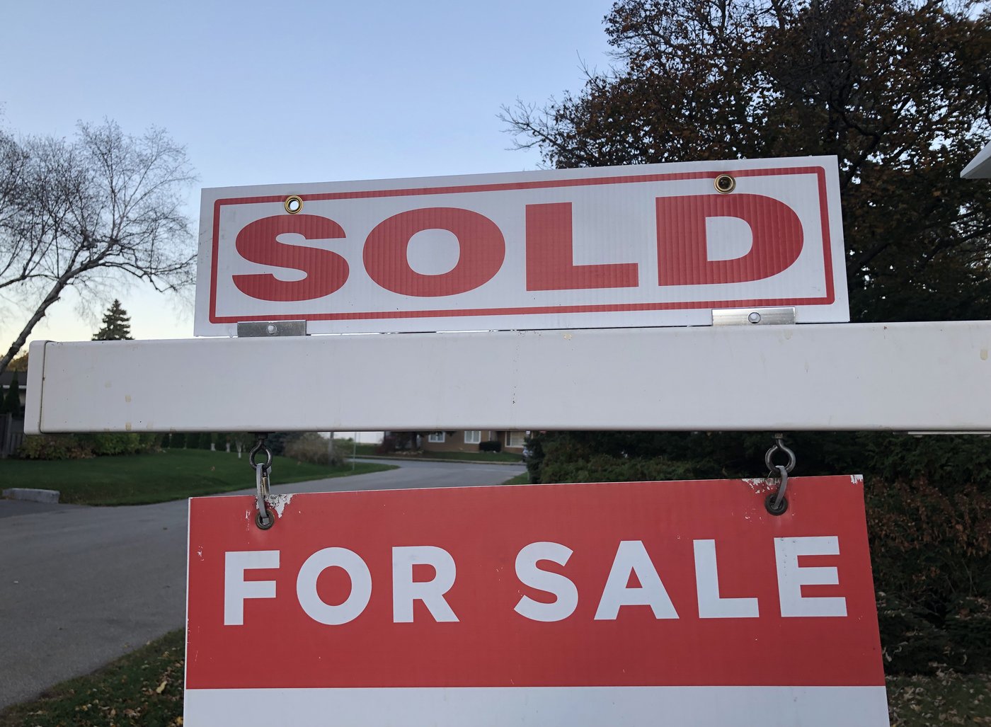 Real estate sale signage is shown on a street in Oakville, Ont., west of Toronto, on Thursday, Nov. 7, 2024. THE CANADIAN PRESS/Richard Buchan