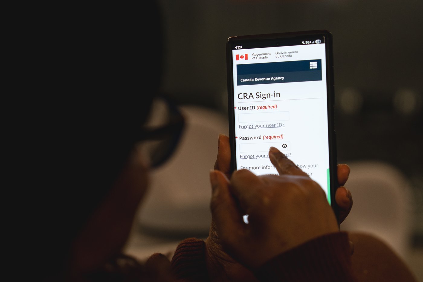 A person looks at the Canada Revenue Agency MyCRA login screen in a photo illustration in Toronto, Saturday, Feb. 28, 2026. THE CANADIAN PRESS/Giordano Ciampini