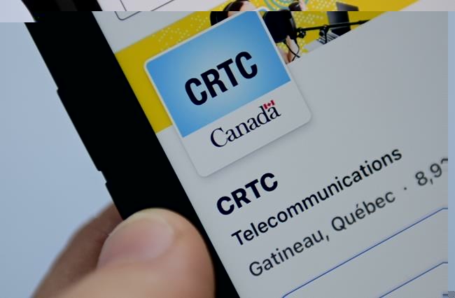 A person navigates to the on-line social-media pages of the Canadian Radio-television and Telecommunications Commission (CRTC) on a cell phone in Ottawa on Monday, May 17, 2021. THE CANADIAN PRESS/Sean Kilpatrick