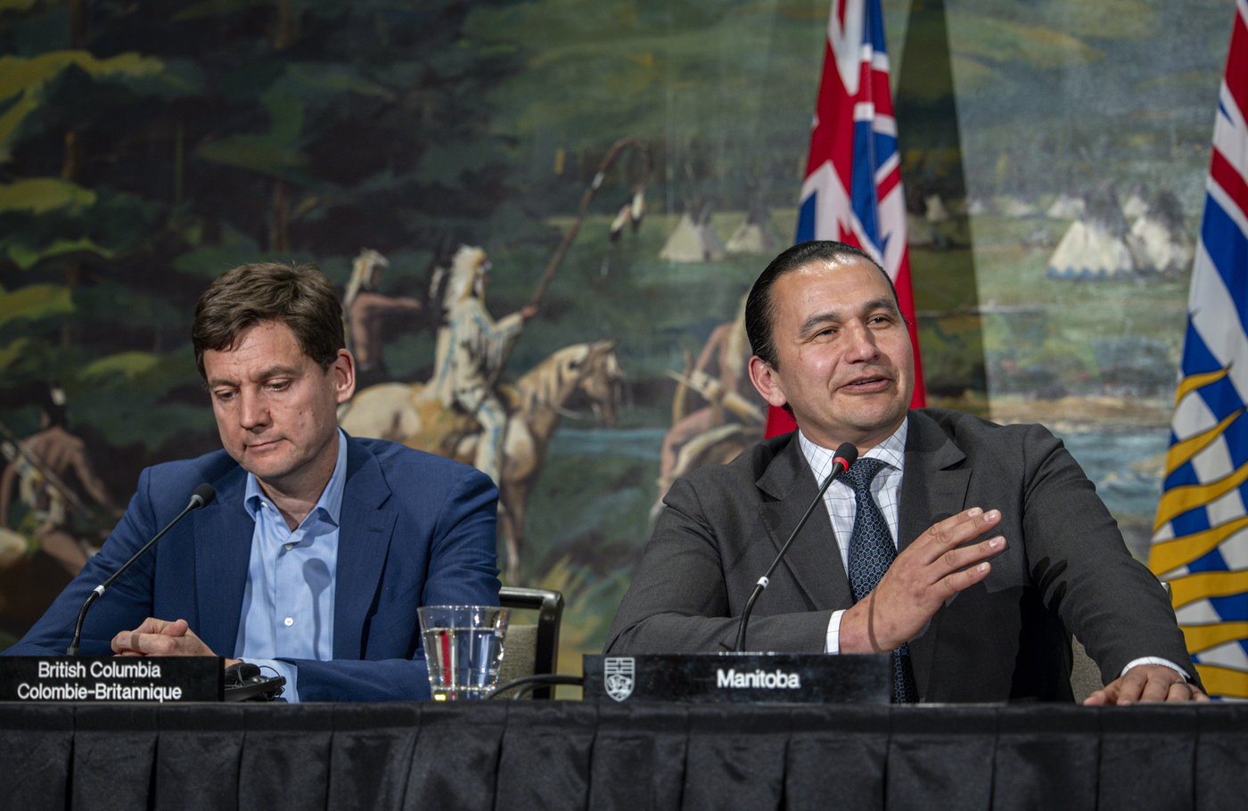 Manitoba Premier Wab Kinew, right, speaks as B.C. Premier David Eby listens during a closing news conference of a meeting of western premiers in Kananaskis, Alta., Tuesday, May 26, 2026. THE CANADIAN PRESS/Jeff McIntosh