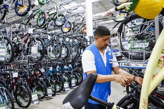 FILE - A worker organizes bicycles at a Walmart Superstore in Secaucus, New Jersey, July 11, 2024. Last month's rise in the unemployment rate has set off new worries about the threat of a recession, but it could also be a false alarm. The distorted post-pandemic economy has already confounded a host of traditional recession signals, at least so far. (AP Photo/Eduardo Munoz Alvarez, File)