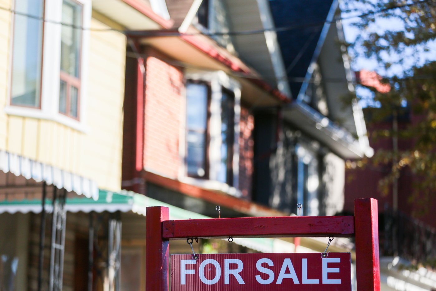 A real estate sign is displayed in front of a house in the Riverdale area of Toronto on Wednesday, Sept. 29, 2021. THE CANADIAN PRESS/Evan Buhler