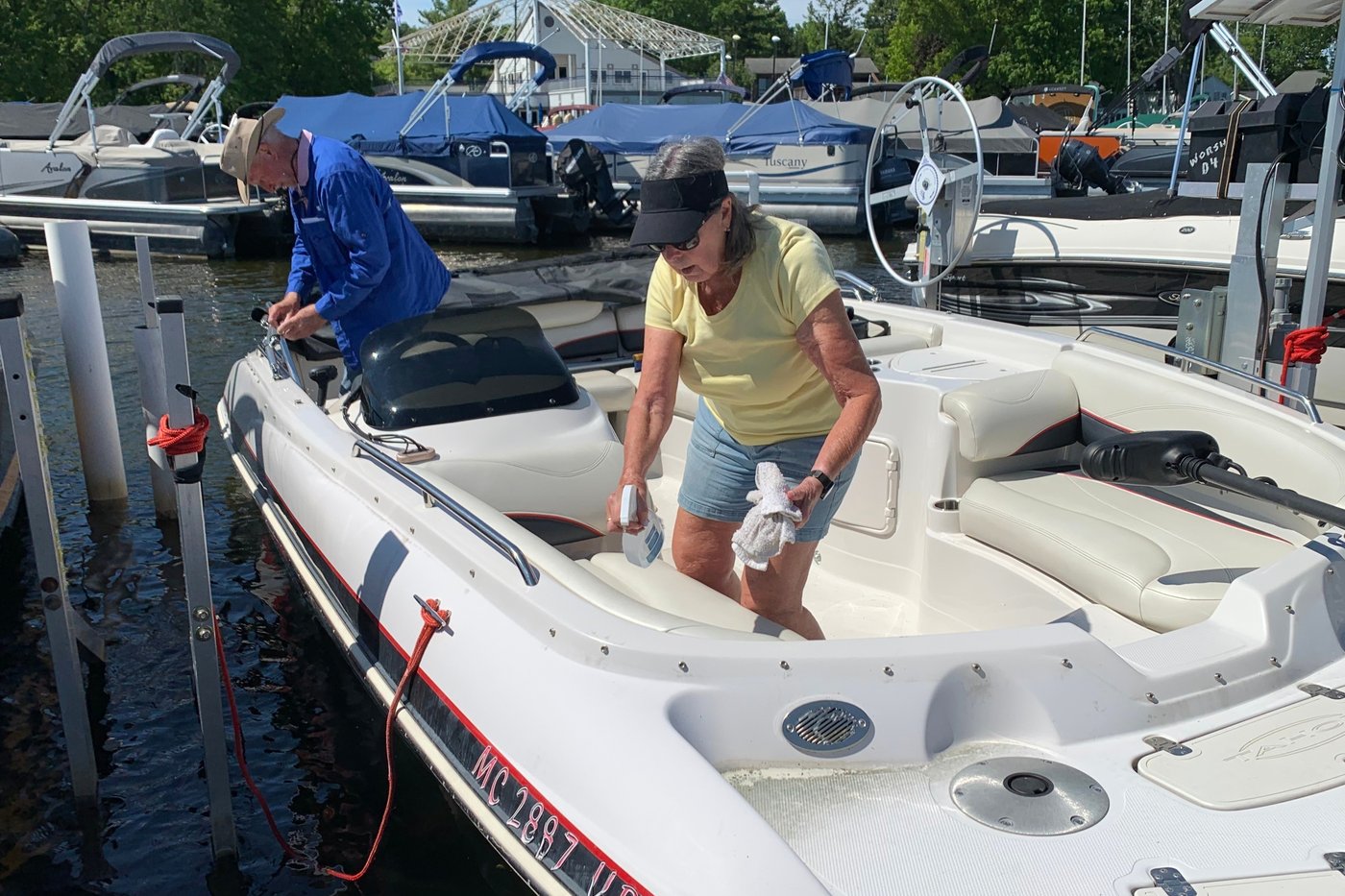 Kay Worsham cleans her boat Sunday, May 31, 2026, in Dexter Township, Mich. (AP Photo/Mike Householder)
