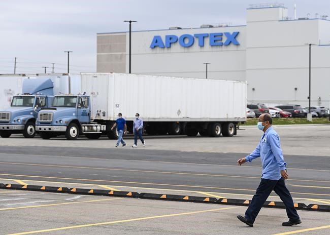 Apotex workers walk outside the company plant in Toronto on Friday, April 9, 2021. Apotex Pharmaceutical Holdings Inc. has signed a deal to be acquired by U.S. private equity investment firm SK Capital Partners. THE CANADIAN PRESS/Nathan Denette