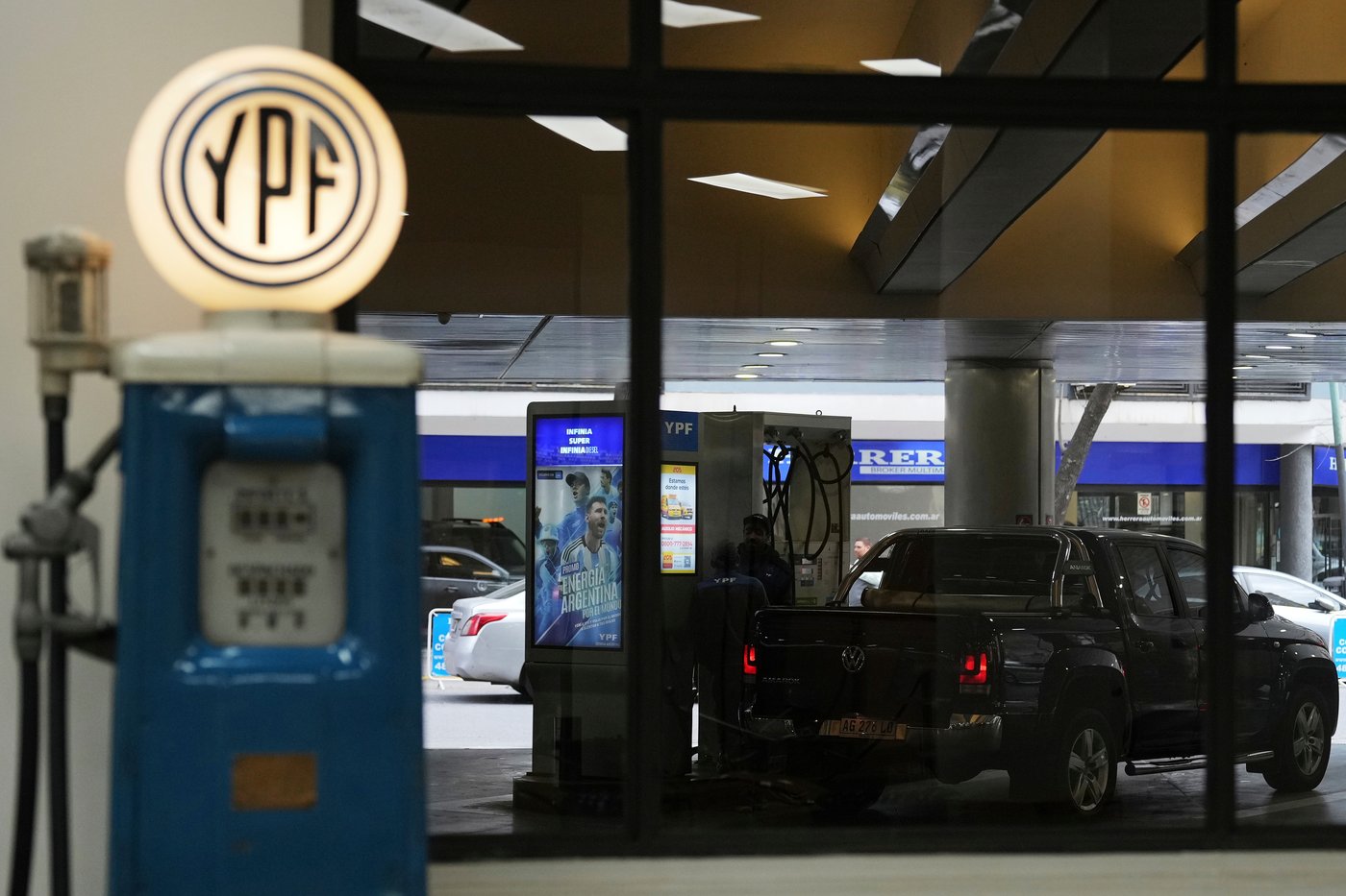 FILE - A worker fuels up a van at a YPF gas station in Buenos Aires, Argentina, July 14, 2025. (AP Photo/Rodrigo Abd, File)
