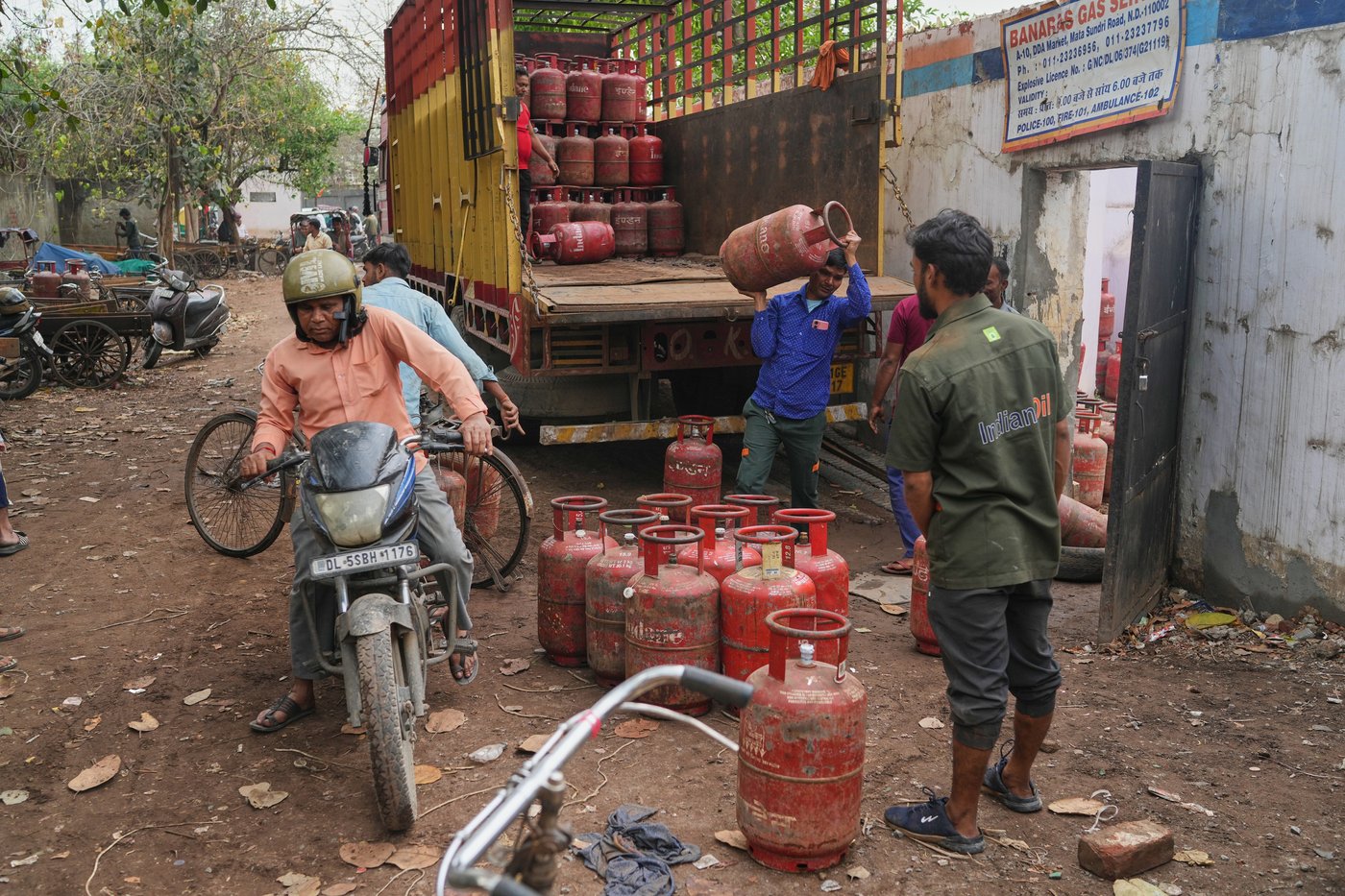 FILE - Workers unload gas cylinders from a truck at a distribution depot in New Delhi, March 19, 2026. (AP Photo/Manish Swarup, File)