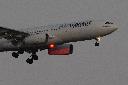 An Air Transat Airbus A330 approaches for landing in Lisbon just before sunrise, Monday, July 22, 2024. (AP Photo/Armando Franca)