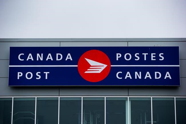The Canada Post logo is seen on the outside the company's Pacific Processing Centre, in Richmond, B.C., on June 1, 2017. THE CANADIAN PRESS/Darryl Dyck