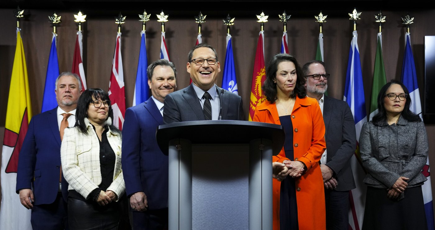 NDP Leader Avi Lewis, centre, hold a press conference with his party on Parliament Hill in Ottawa on Monday, April 13, 2026. THE CANADIAN PRESS/Sean Kilpatrick