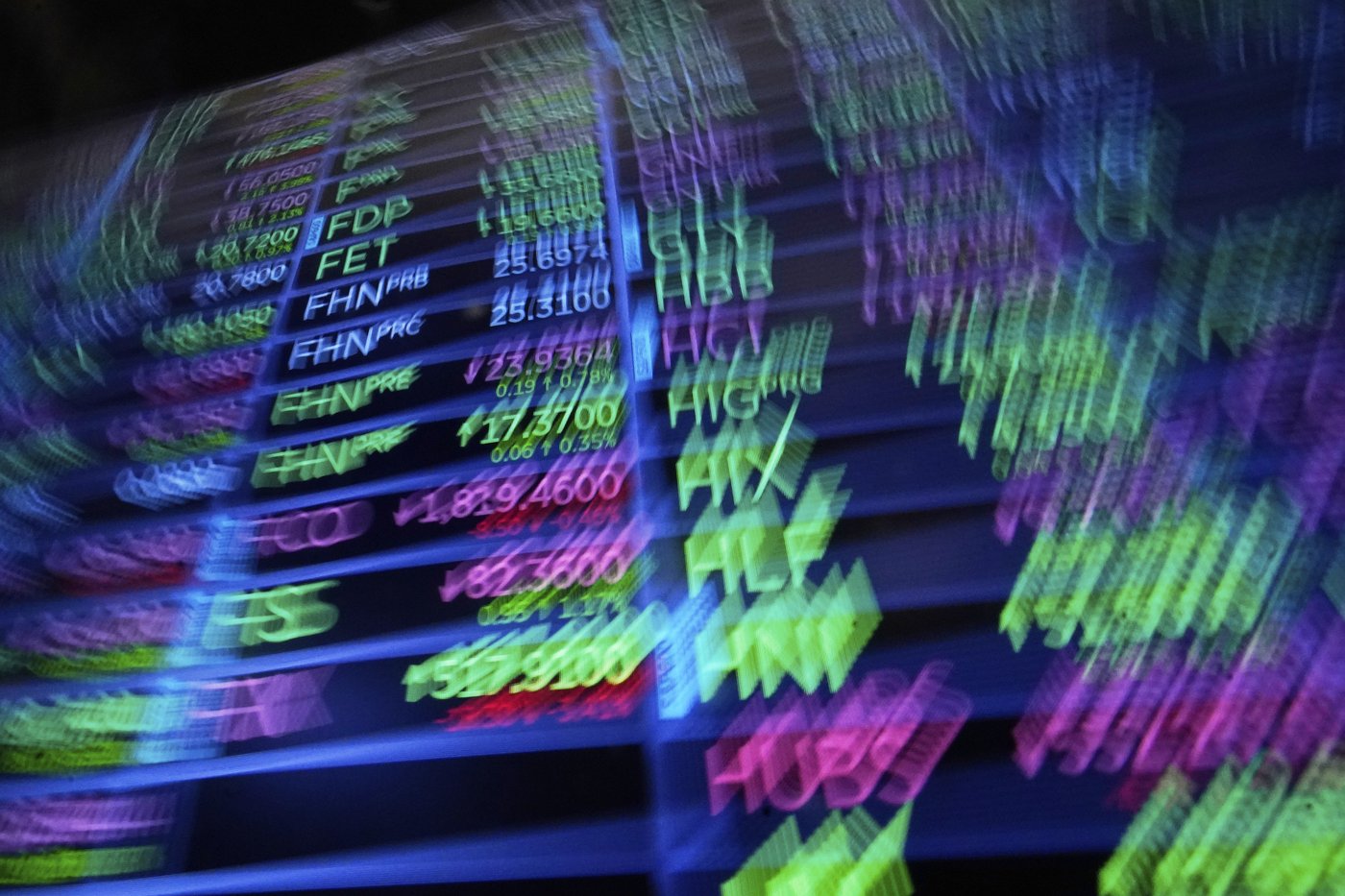 A board above the trading floor of the New York Stock Exchange with stock symbols is shown in this image, Tuesday, July 1, 2025. (AP Photo/Richard Drew)