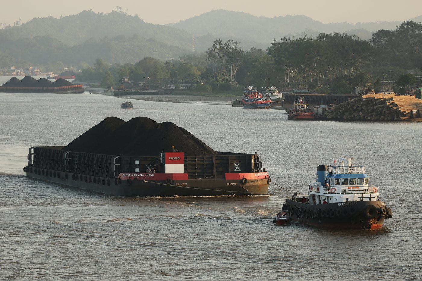 A tug boat pulls a barge loaded with coal on Mahakam River in Samarinda, East Kalimantan, Indonesia, on Aug. 19, 2026. (AP Photo/Ahmad Mulia Panjaitan)