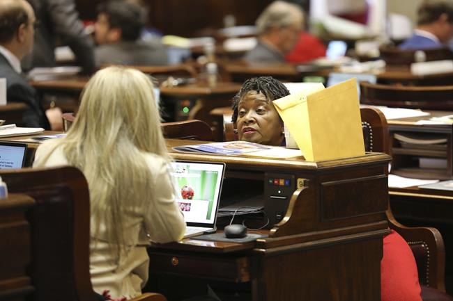 South Carolina Rep. Beth Bernstein, D-Columbia, left, and Rep. Annie McDaniel, D-Winnsboro, speak as the House debates a bill to allow Sunday liquor sales in the state on Wednesday, Feb. 14, 2024, in Columbia, S.C. (AP Photo/Jeffrey Collins)