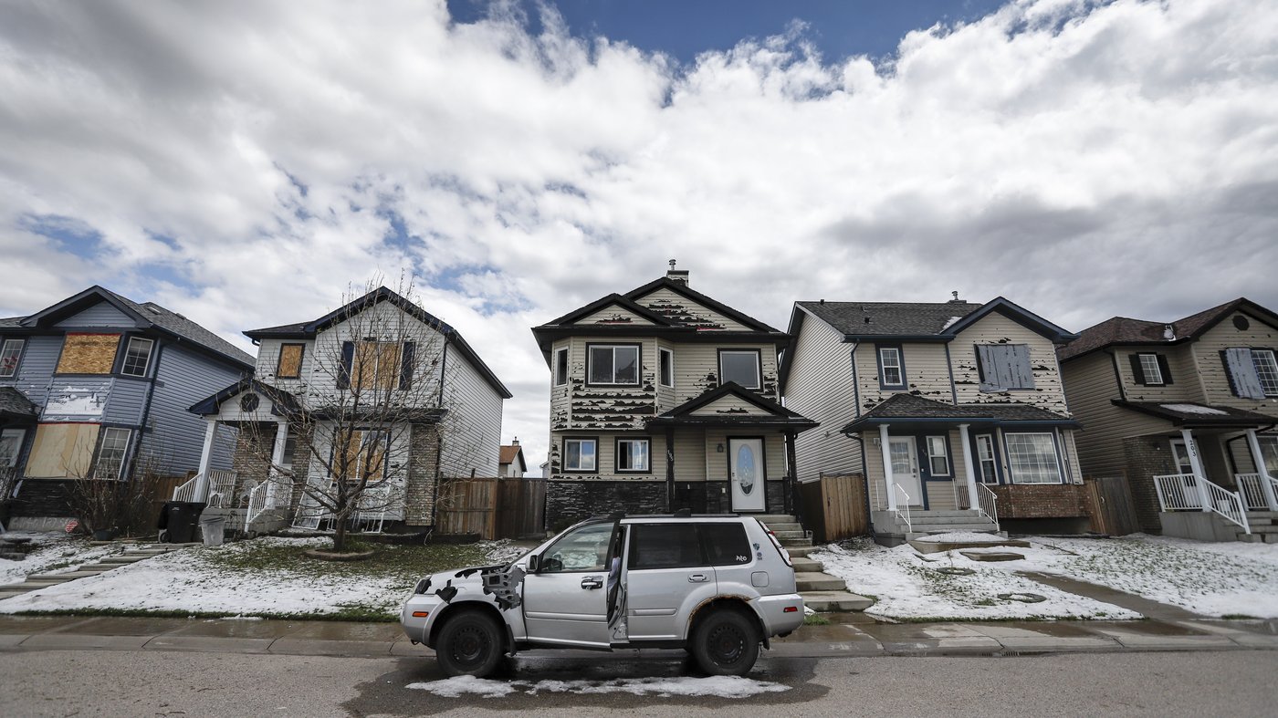Residents survey the damage before beginning cleanup in Calgary, Alta., Sunday, June 14, 2020, after a major hailstorm damaged homes and flooded streets on Saturday.THE CANADIAN PRESS/Jeff McIntosh