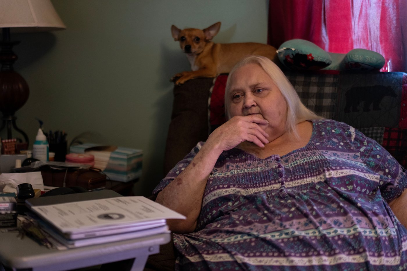 Rebecca Michalski pauses as she talks about electric bills she cannot pay while sitting next to her Chihuahua, Enos, at her home in Rainelle, W.Va., Saturday, March 21, 2026. (AP Photo/Carolyn Kaster)