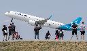 People look on as an Air Transat plane takes off at Pierre Elliott Trudeau International Airport in Montreal, Sunday, June 11, 2023. THE CANADIAN PRESS/Graham Hughes