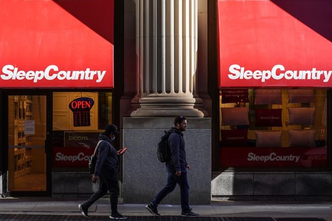 Pedestrians walk past a Sleep Country Canada store on Yonge Street in Toronto on October 19, 2021. THE CANADIAN PRESS/Evan Buhler