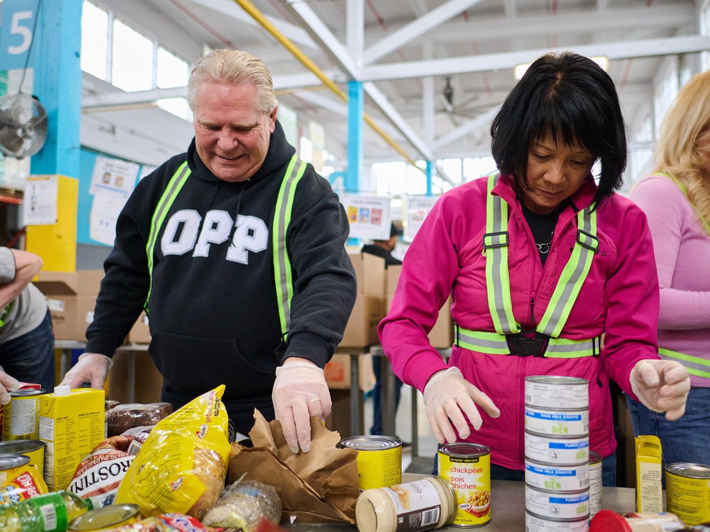 Ontario Premier Doug Ford, left, and Toronto Mayor Olivia Chow help pack and sort food donations at the Daily Bread Food Bank’s spring public food sort in Toronto, on Saturday, April 4, 2026. THE CANADIAN PRESS/Sammy Kogan