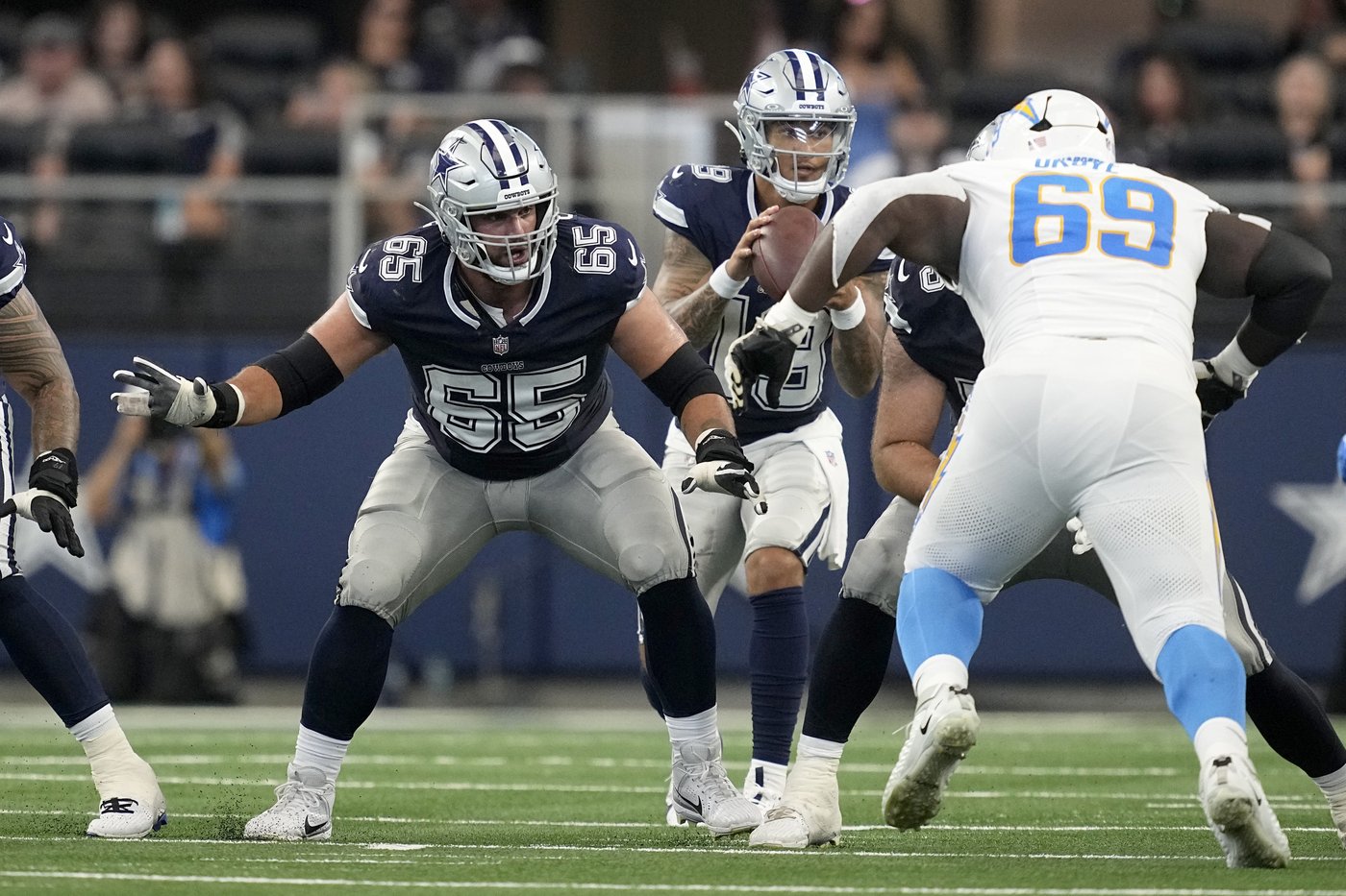 Dallas Cowboys offensive tackle Dakoda Shepley (65) defends against a rush by Los Angeles Chargers' CJ Okoye (69) during a pre-season NFL football game, Saturday, Aug. 24, 2024, in Arlington, Texas. (AP Photo/Tony Gutierrez)