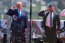 President Donald Trump, left, and Secretary of Homeland Security Markwayne Mullin, right, saluting at the start of the commencement ceremony at the U.S. Coast Guard Academy in New London, Conn., Wednesday, May 20, 2026. (AP Photo/Jessica Hill)