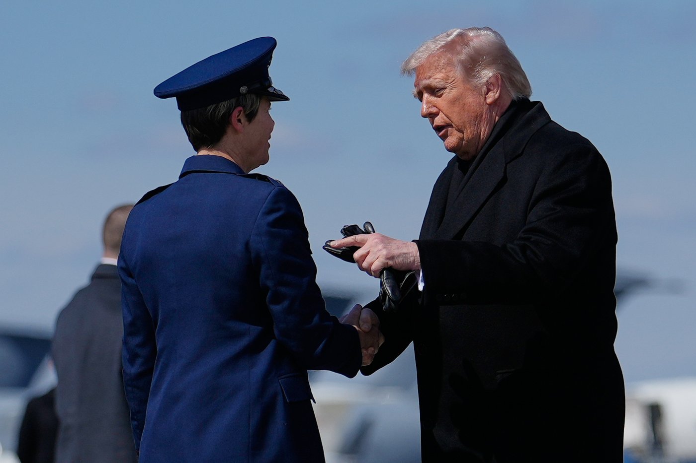 President Donald Trump greets Col. Matha "Jeannie" Sasnett, commander of Air Force Mortuary Affairs, as he arrives on Air Force One, Wednesday, March 18, 2026, at Dover Air Force Base, Del., to attend the casualty return for the six crew members of an Air Force refueling aircraft who died when their plane crashed in western Iraq while supporting operations against Iran. (AP Photo/Julia Demaree Nikhinson)