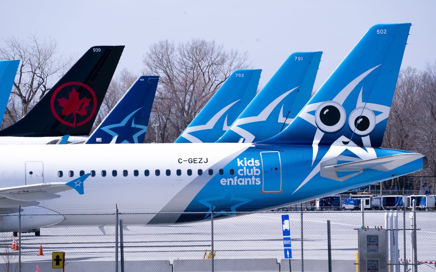 Air Transat and an Air Canada aircraft are seen on the tarmac at Montreal-Trudeau International Airport in Montreal, on Wednesday, April 8, 2020. THE CANADIAN PRESS/Paul Chiasson