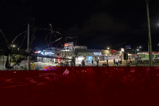 FILE- Residents stand in a blockade in Noumea, New Caledonia, on May, 15, 2024. Global nickel prices have soared since deadly violence erupted in the French Pacific territory of New Caledonia. (AP Photo/Nicolas Job, File)