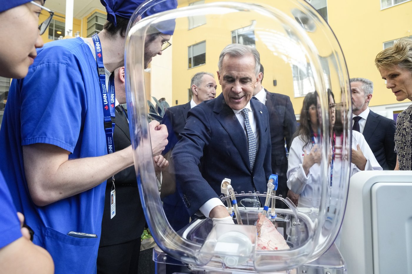Prime Minister Mark Carney inspects a pig's lungs during an AI demonstration as they visit Toronto General Hospital on Thursday, June 4 2026.THE CANADIAN PRESS/Chris Young