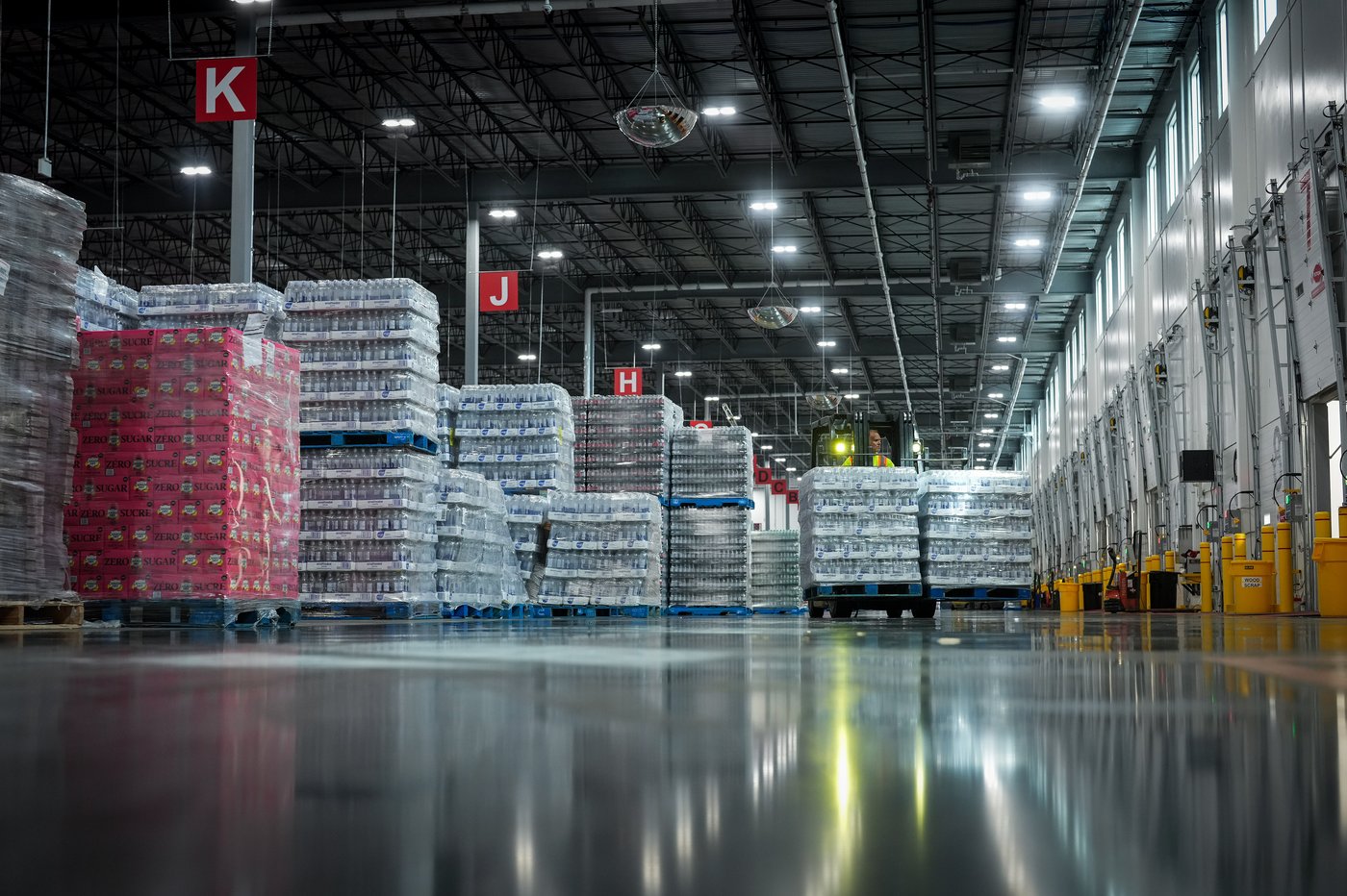 Canadian warehouse leasing numbers surged last year as shippers sought flexibility and a way to work around U.S. tariffs, a new report says. An employee moves Coca-Cola products at Coke Canada Bottling's new sales warehouse and distribution centre, in Richmond, B.C., on Wednesday, Aug. 14, 2024. THE CANADIAN PRESS/Darryl Dyck